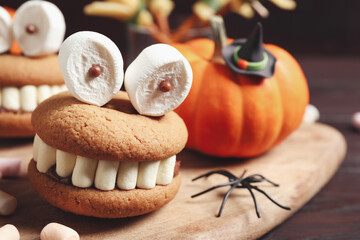 Delicious Halloween themed dessert on wooden table, closeup
