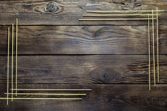 Italian spaghetti frame on the wooden board with copy space