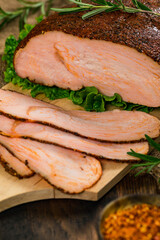 Roasted Turkey Breast Cajun Style Deli Lunch Meat on Old Wooden Background. Selective focus.