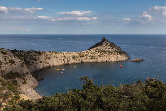 Beautiful seascape, panorama of cape Kapchik to the Galitsin Trail and blue bay of the Black Sea. Sudak, New World, Crimea. Landscape of the sea coast.