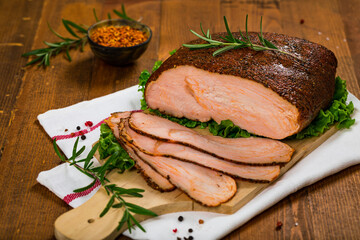 Roasted Turkey Breast Cajun Style Deli Lunch Meat on Old Wooden Background. Selective focus.