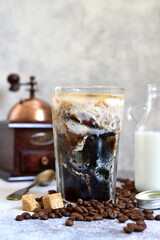 Homemade delicious iced coffee or frappe in a tall glass.