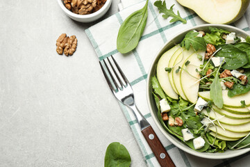 Tasty salad with pear slices served on light grey table, flat lay. Space for text