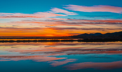Sunset coluros  over the lake with reflection 