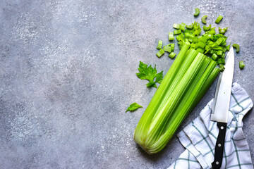 Fresh sliced organic celery with knife. Top view with copy space.