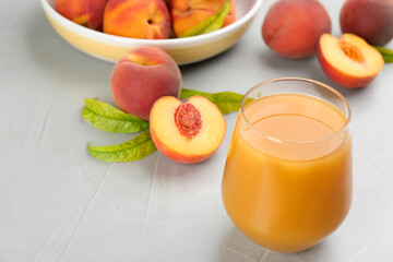 Natural freshly made peach juice on light table, closeup