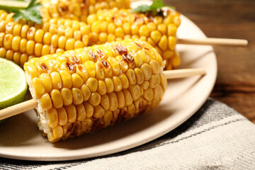 Tasty grilled corn on table, closeup view