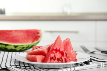 Yummy cut watermelon on table in kitchen, closeup