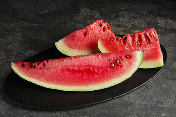 Yummy watermelon slices on grey table, closeup