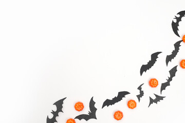 halloween layout with pumpkins and bats on white background copy space