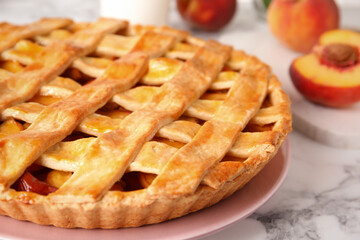 Delicious peach pie on white marble table, closeup