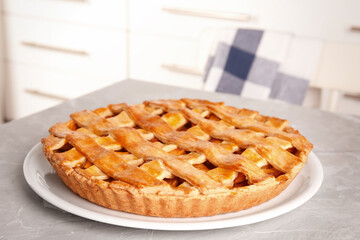Delicious fresh peach pie on grey kitchen table, closeup