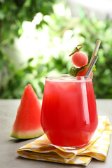 Delicious fresh watermelon drink on grey table