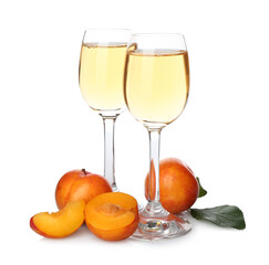 Delicious plum liquor and ripe fruits on white background. Homemade strong alcoholic beverage