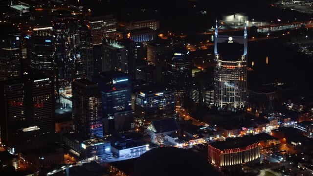 Smooth aerial camera movement over downtown Nashville with views of Broadway at night