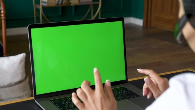 Asian Indian Woman Using Computer Laptop with green screen at home. Online Conference call, Training with People, using a Computer. Bright Room At Home