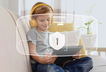Child safety online. Little boy using tablet at home. Illustration of internet blocking app on...