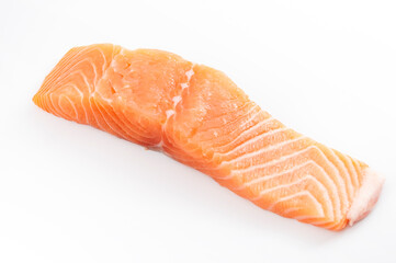 Fish rich in Omega 3 and healthy fatty acids, healthy source of protein and seafood nourishment concept with pink raw salmon fillet strip isolated on a white background