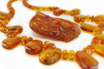 Necklace made of Baltic amber isolated on a white background. Piece of yellow translucent natural amber in the middle. Beautiful jevelry for woman