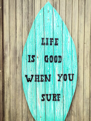 Life is good when you surf - grungy wooden sign