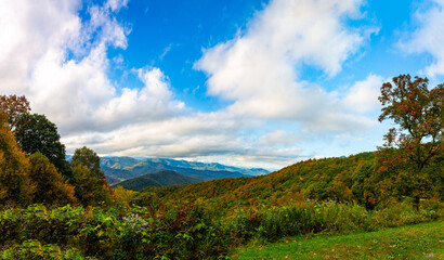 View from one of blue ridge parkway observation spots toward great smoky mountain's picks during bright, sunny day 