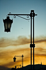 Retro street lamps on the Roman bridge in Ponte de Lima, Portugal. Beautiful evening sky.