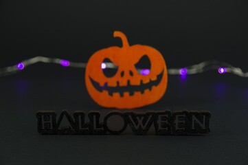 funny pumpkin and bat on black background. halloween party