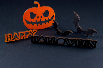 funny pumpkin and bat on black background. halloween party