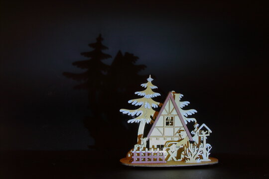 model of plywood hut immersed in winter atmospheres with a fearful reflection of the forest
