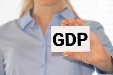 GDP or Gross Domestic Product letters on the card shown by a man