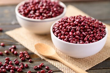 Azuki beans or red mung bean in a bowl and spoon on wooden table