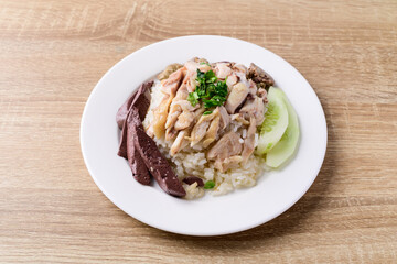 Thai food (Khao Man Kai), Hainanese chicken rice on wooden background