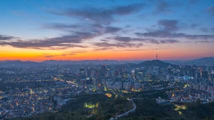 Fototapeta na wymiar morning Seoul city skyline and Seoul tower modern building and architecture, Beautiful clouds flow through during sunrise,seen from inwang san The best view of Seoul South,Korea.