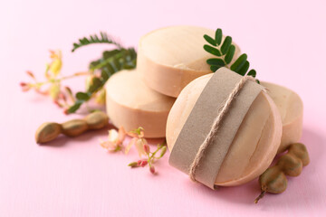 Tamarind soap on pink background, organic natural product for skin care