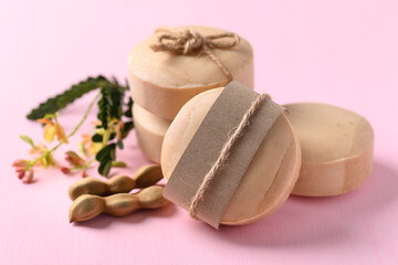 Tamarind soap on pink background, organic natural product for skin care