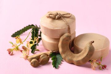 Tamarind soap on pink background, organic natural product for skin care