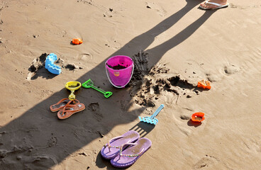 Photo of children's toys on the beach sand.