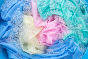 Color clothes soak in powder detergent water dissolution. Laundry concept