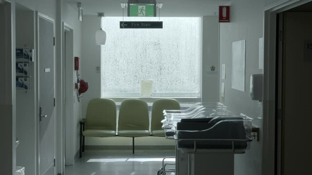 Hospital Corridor With Baby Capsules Bedding In Maternity Ward