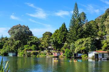 Fototapeta na wymiar Lakefront houses with boatsheds on beautiful Lake Rotoiti, New Zealand