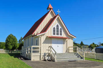 A small wooden church in the sunny countryside