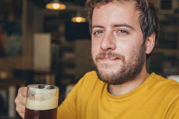 happy man drinking beer in a restaurant