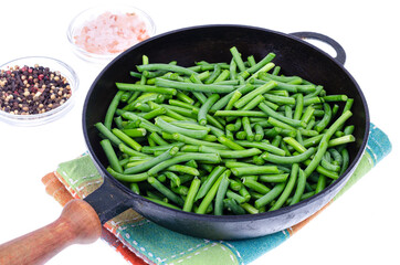 Green fresh green beans in frying pan