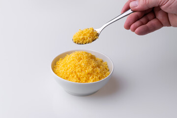 Brazilian Northeast Couscous (Cuscuz Nordestino). Maize couscous on white background