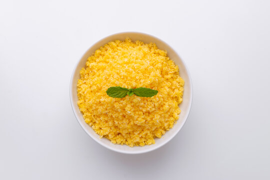 Brazilian Northeast Couscous (Cuscuz Nordestino). Maize couscous on white background