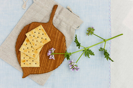 Crackers and wooden coaster on wooden table