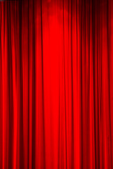 Red curtain background or backdrop copy-space, with folds and creases.