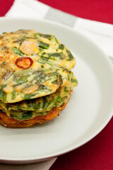 Korean food, korean pancake (Pajeon and Kimchi-jeon) on red background.