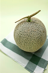 A melon on green background.