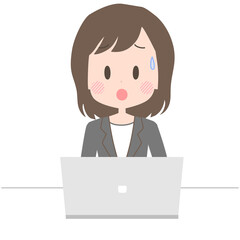 困った表情でノートパソコンを操作するビジネスウーマン